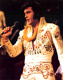 Elvis Presley in concert, from the 1973 television broadcast Elvis: Aloha from Hawaii. Wikipedia